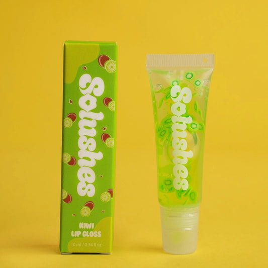 Green lip gloss tube and packaging on a yellow background