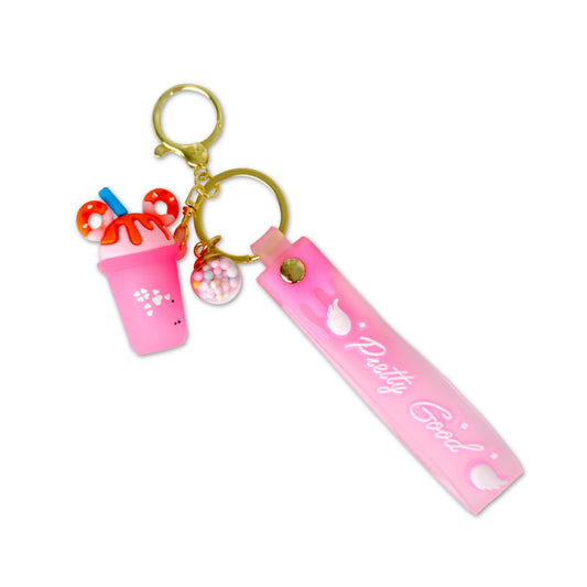 Pink keychain with 'Pretty Good' tag and drink cup charm on a white background