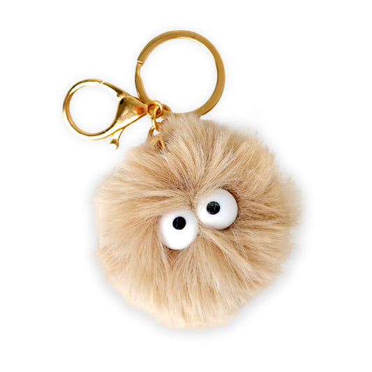 Pom-pom keychain with googly eyes on a white background