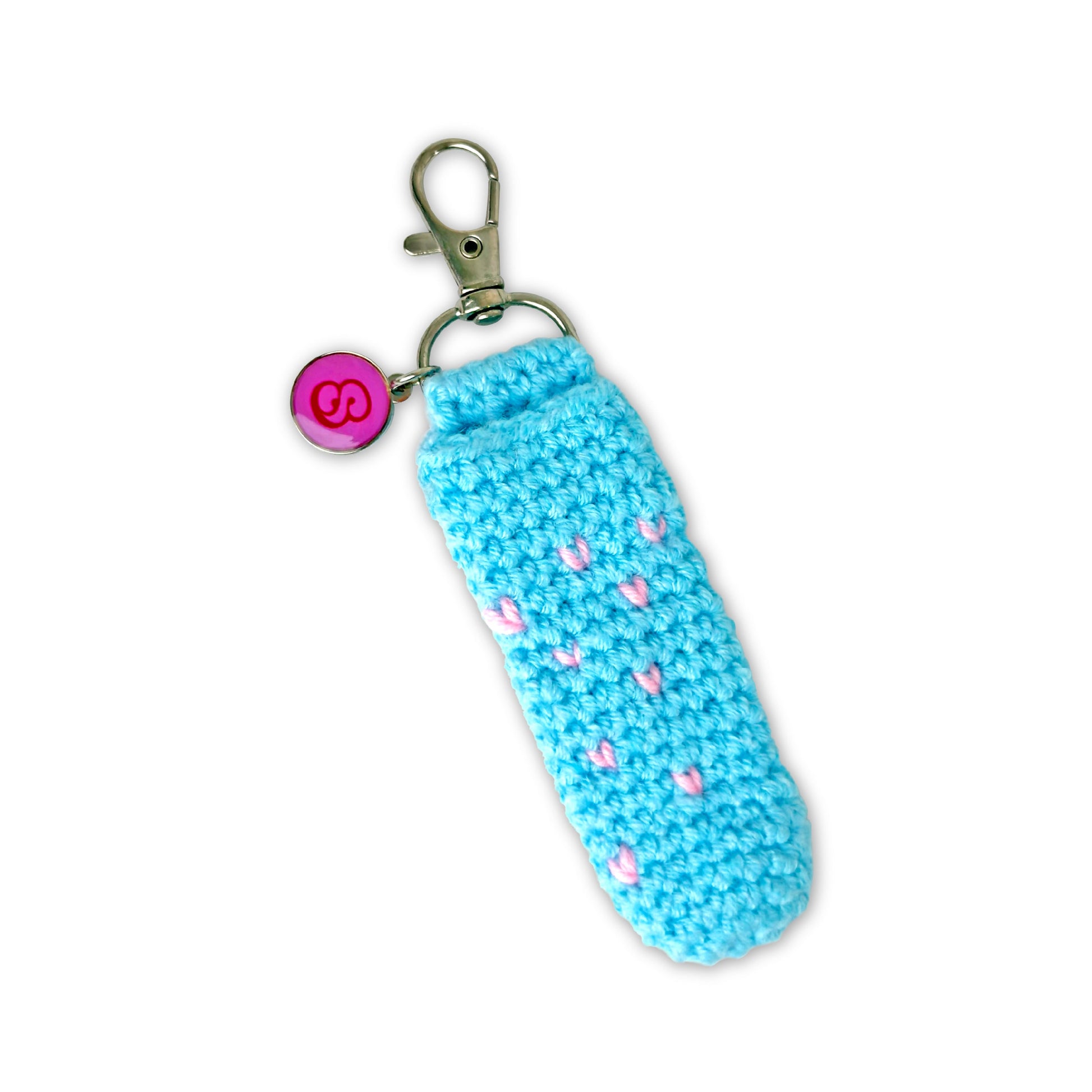 Blue crocheted keychain with pink hearts on a white background