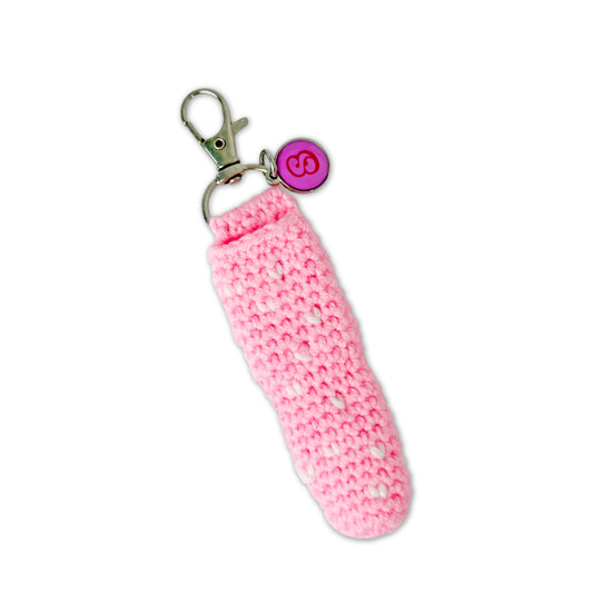Pink crocheted keychain with a metal clasp on a white background