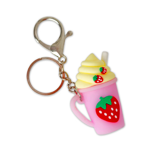 Keychain shaped like a pink ice cream cone with a strawberry on a white background