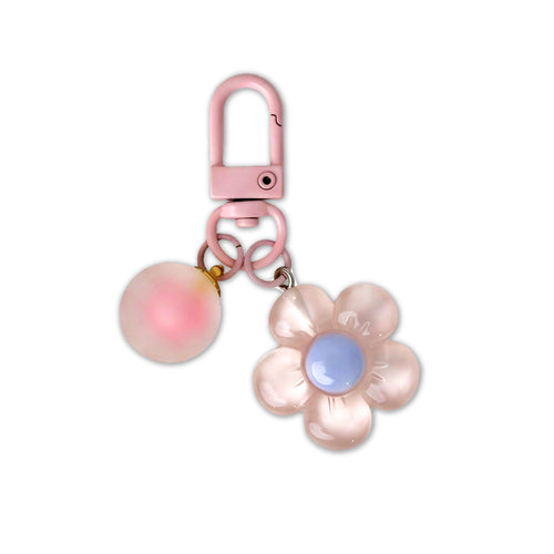 Pink flower-shaped keychain with a carabiner on a white background