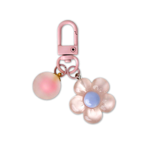 Pink flower-shaped keychain with a carabiner on a white background