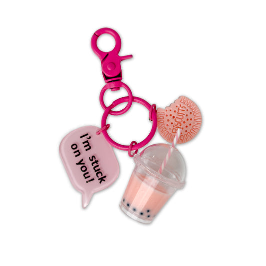 Keychain with pink cup, pink heart, and pink speech bubble on a white background